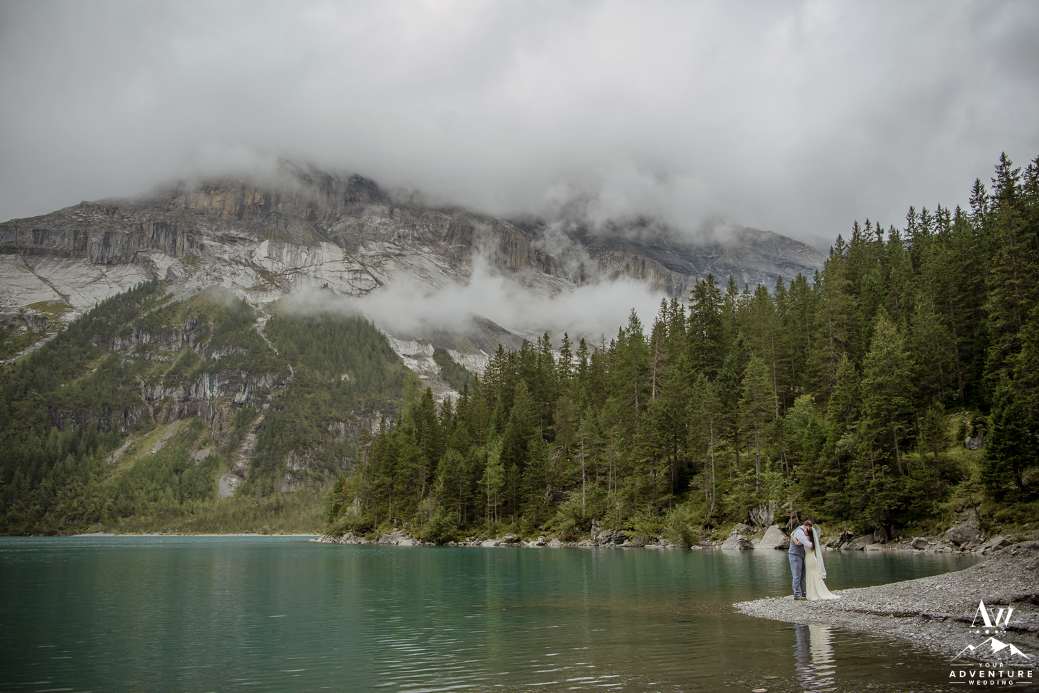 Couple kissing on oeschinensee lake in Switzerland
