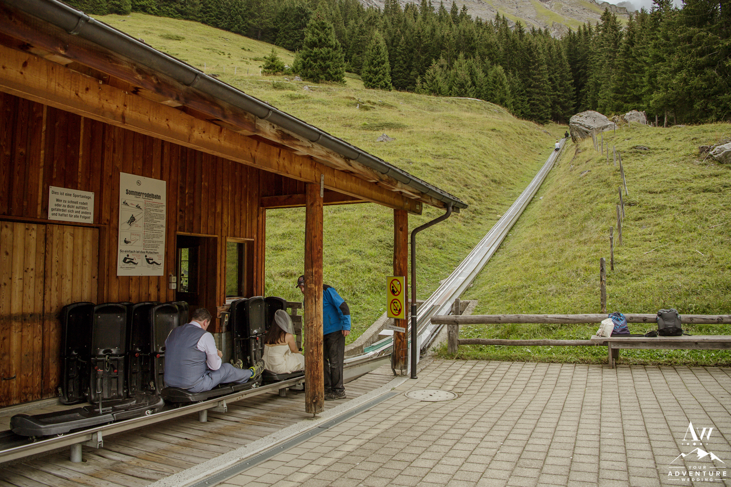 bride and groom ride the mountain roller coaster at oeschinensee lake
