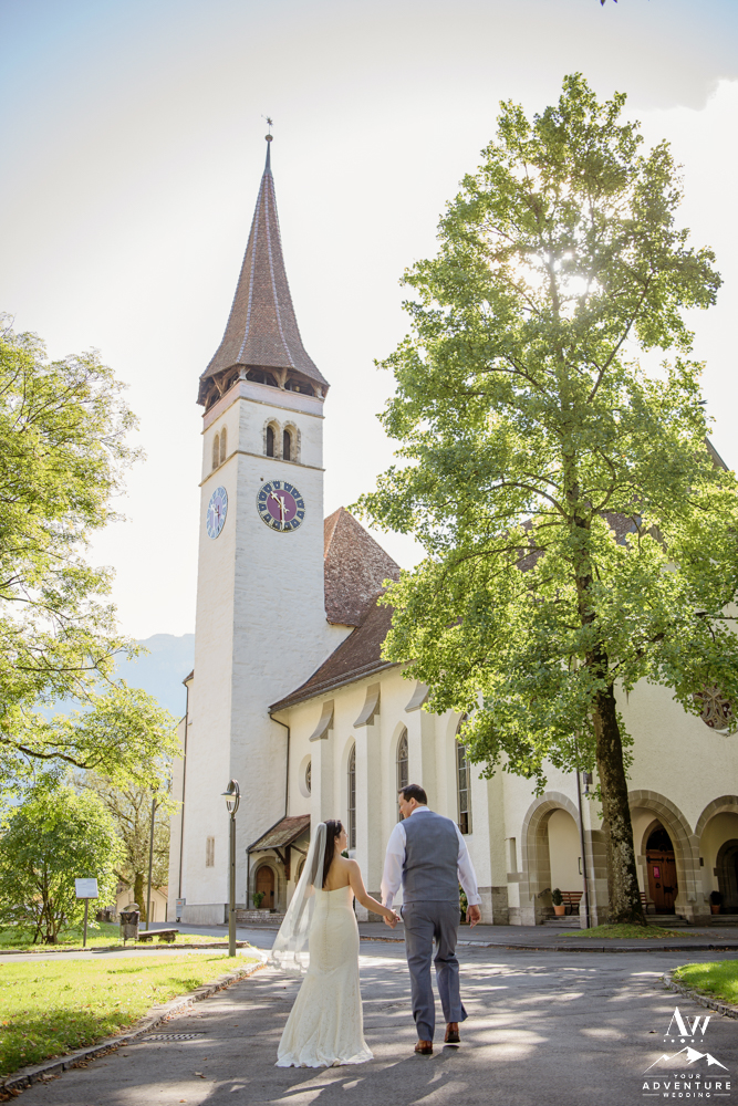 Couple walking outside of a church in Switzerland