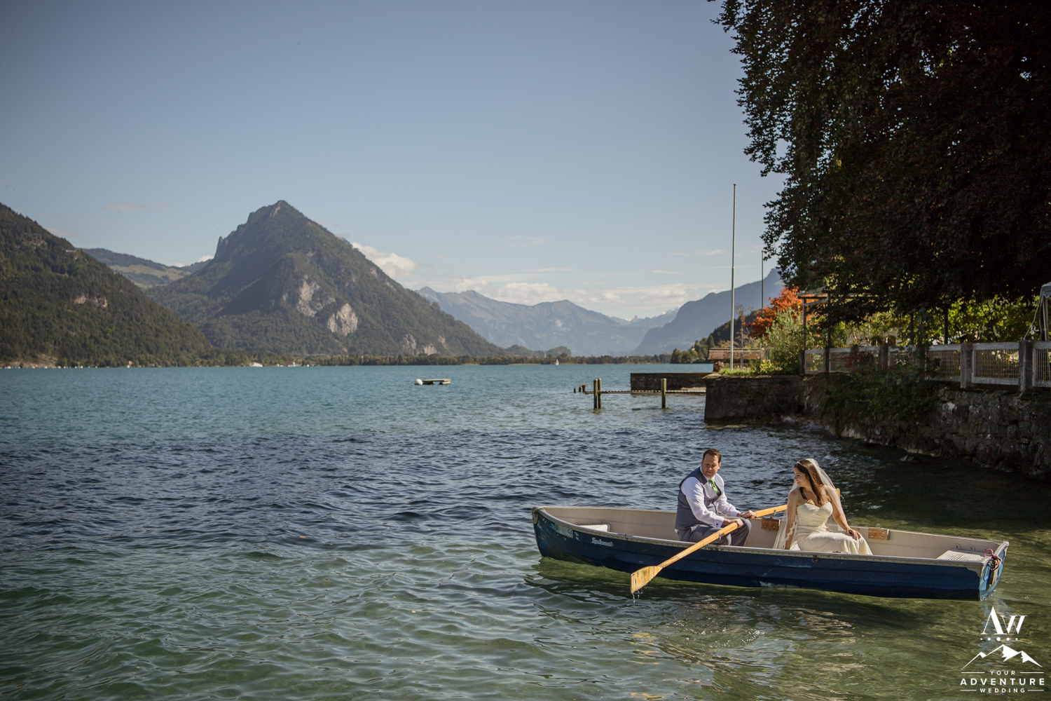 Groom rowing a boat on Switzerland Elopement