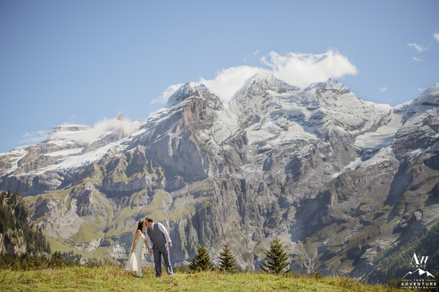 Couple kissing in front of the Alps in Switzerland