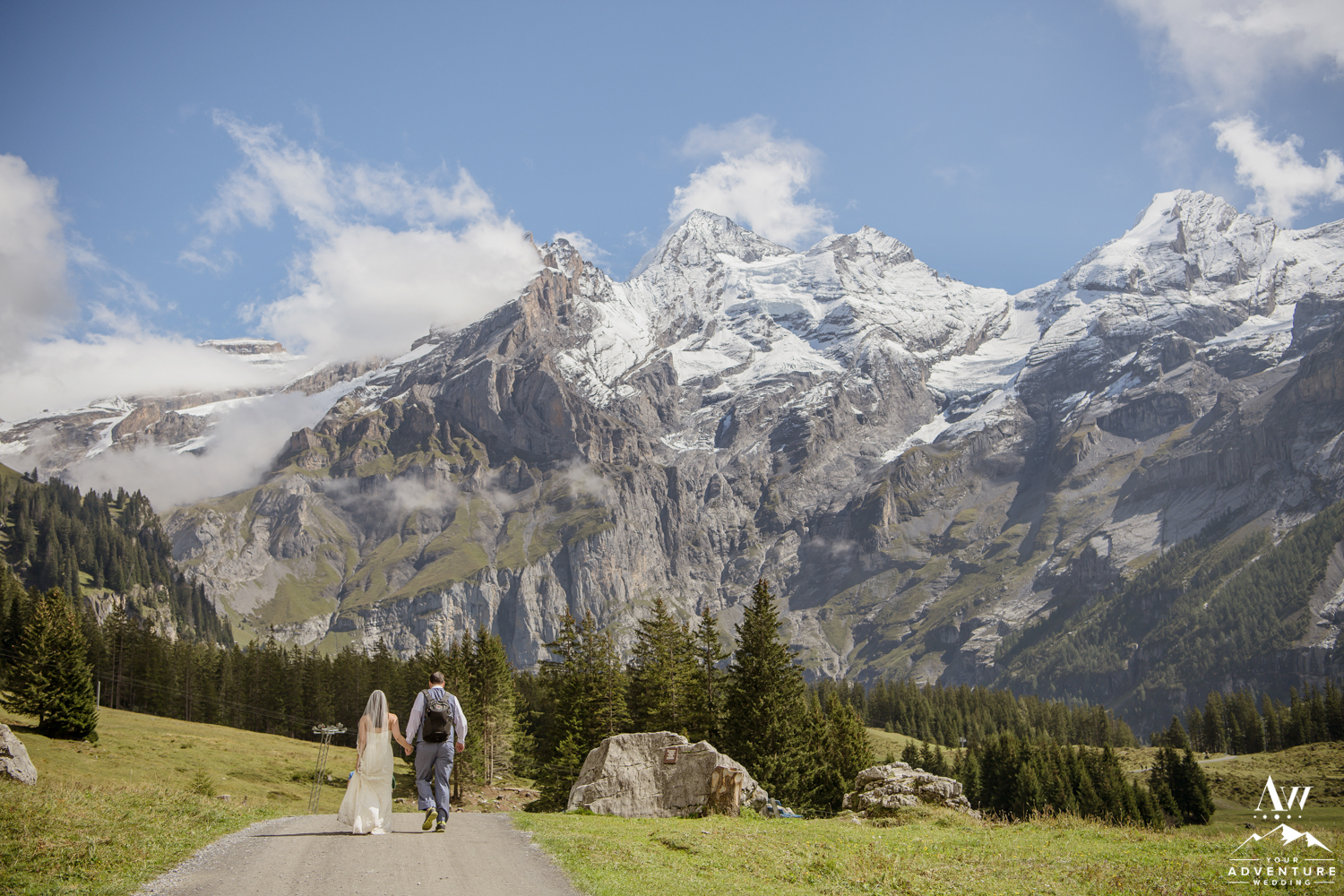Couple hiking in the Swiss Alps on wedding day