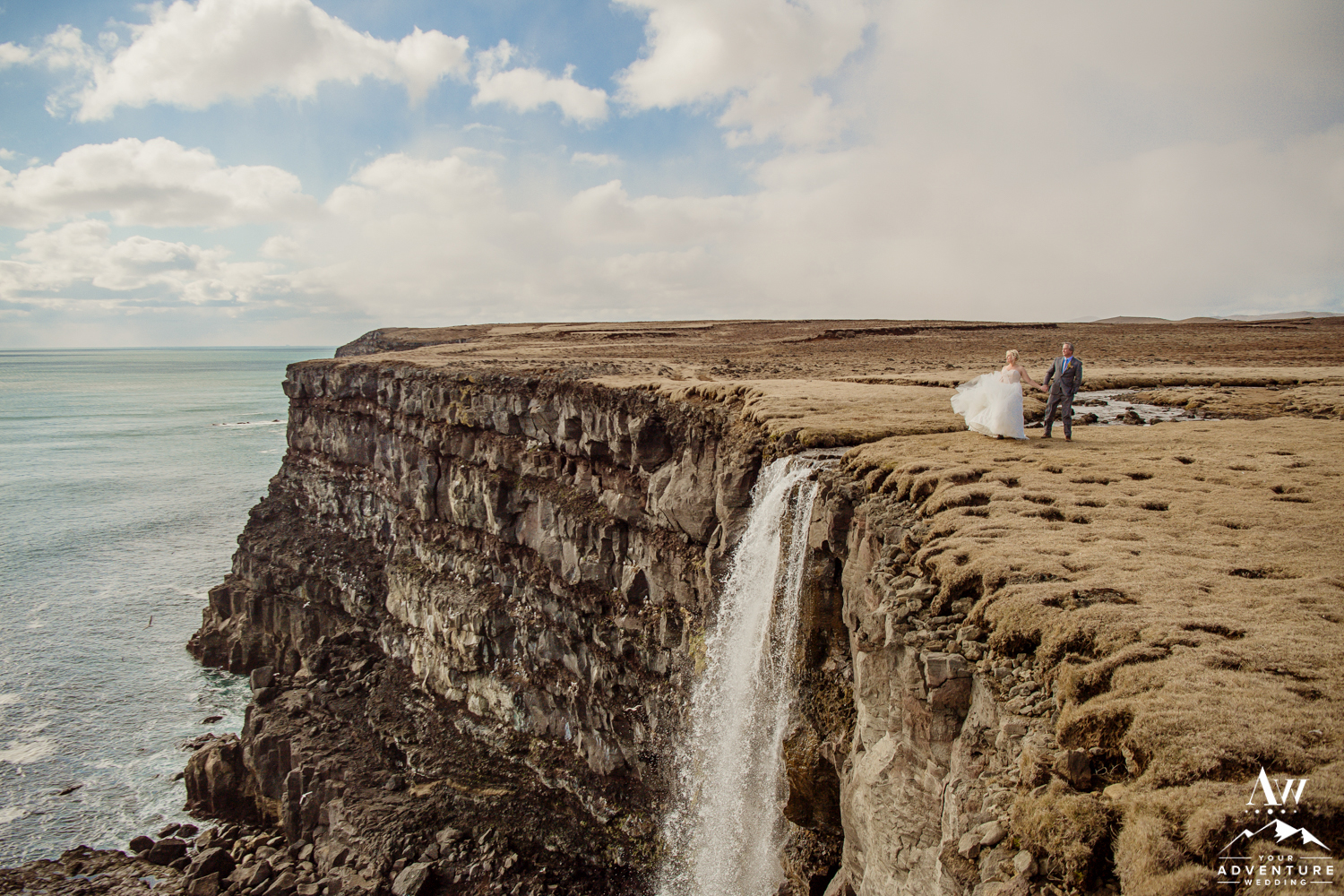 Iceland Elopement Couple on Cliff during wedding adventure