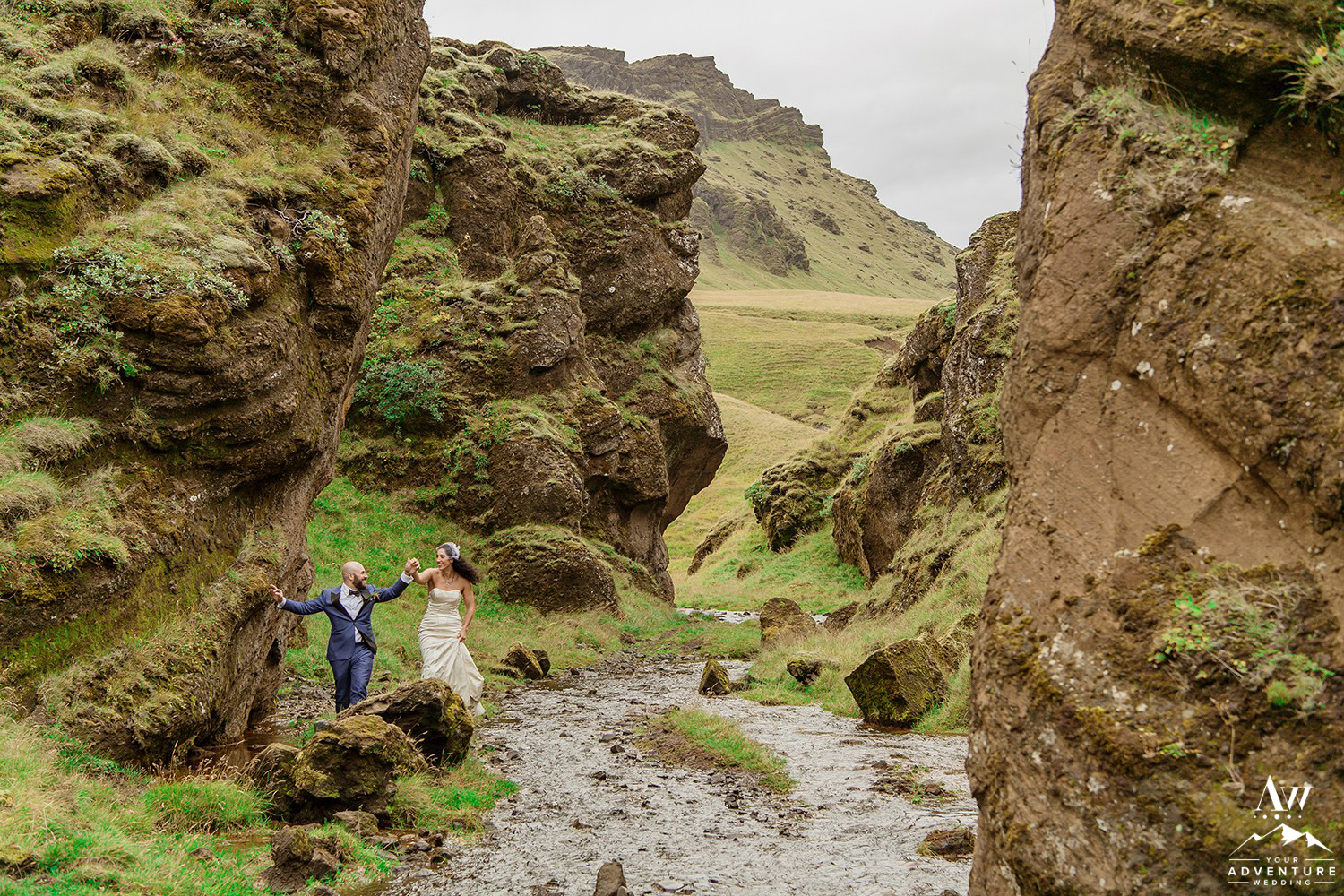 Couple Hiking in a Canyon During their Adventure Wedding Day in Iceland
