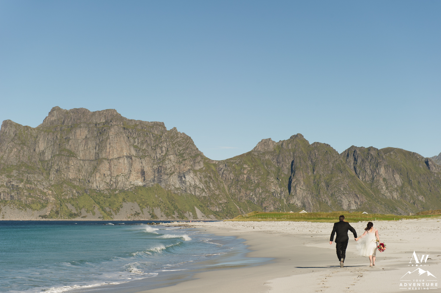Couple Running on a white sand Beach in the Lofoten Islands