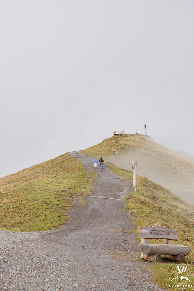 Couple hiking to the Männlichen Summit during Switzerland Elopement
