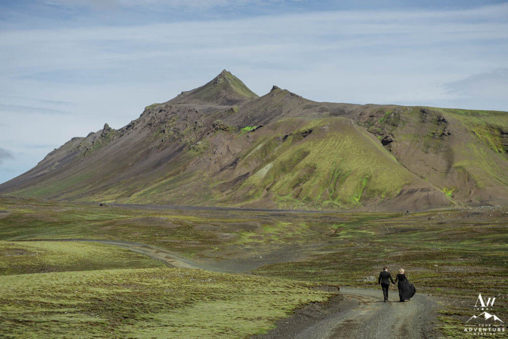Black Dress Bride walking down a mountain road in Iceland