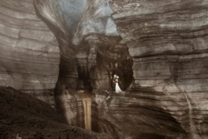 Iceland Wedding Couple inside of an ice cave waterfall