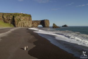 Elopement Budget - Couple walking on black beach