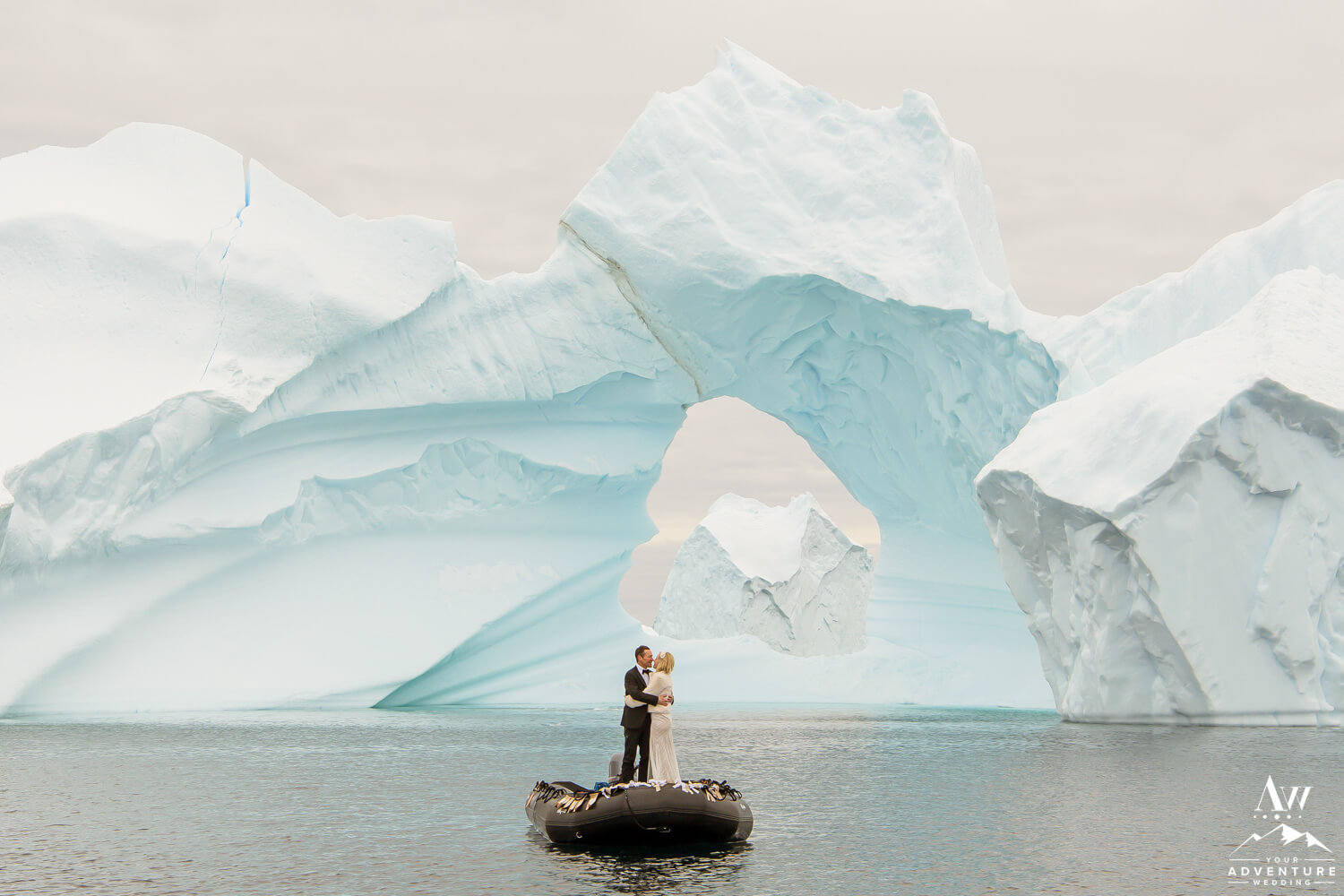 Couple Kissing in front of an Antarctica Iceberg